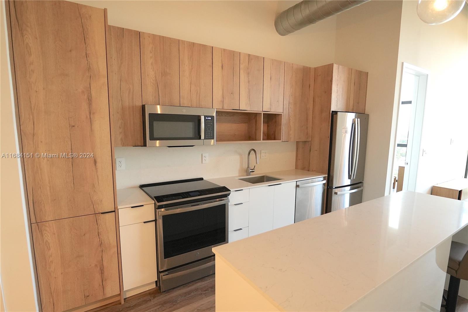 a kitchen with a refrigerator stove and microwave