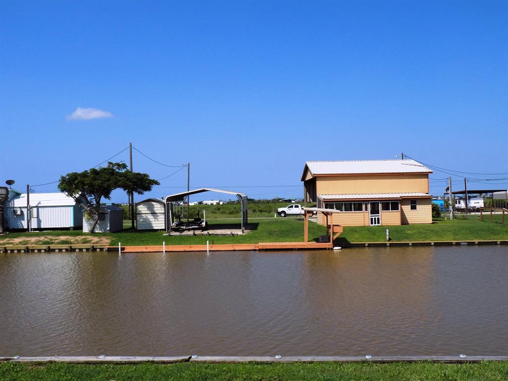 a view of a lake with houses in the background