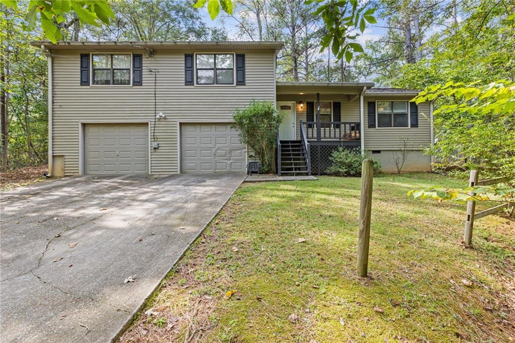 a view of house with backyard and trees