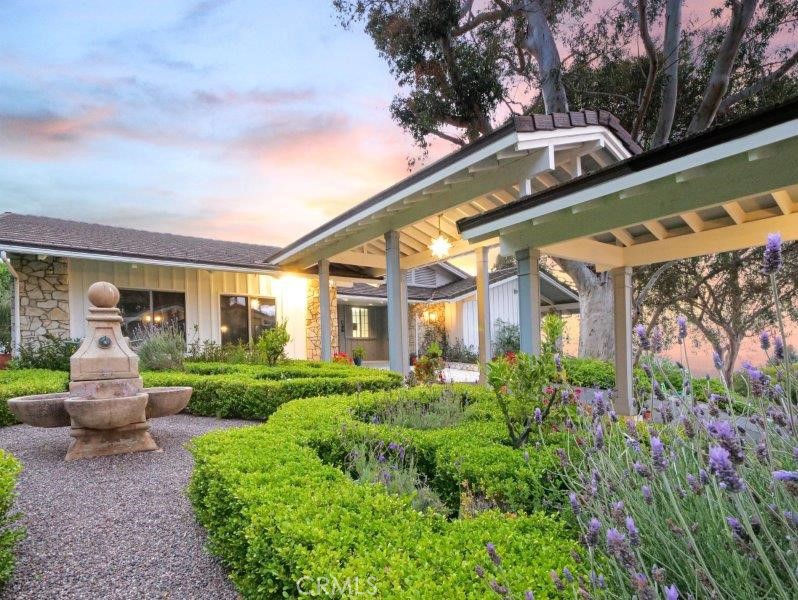 a front view of house with a garden