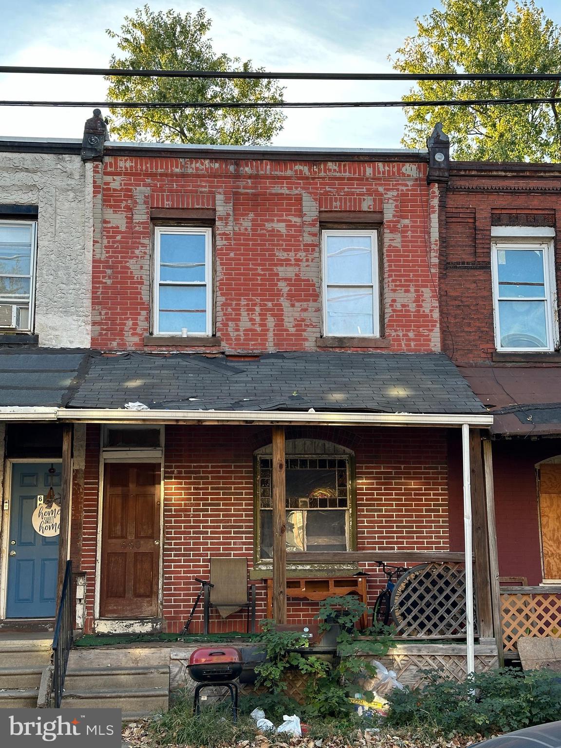 front view of a brick house with a small yard