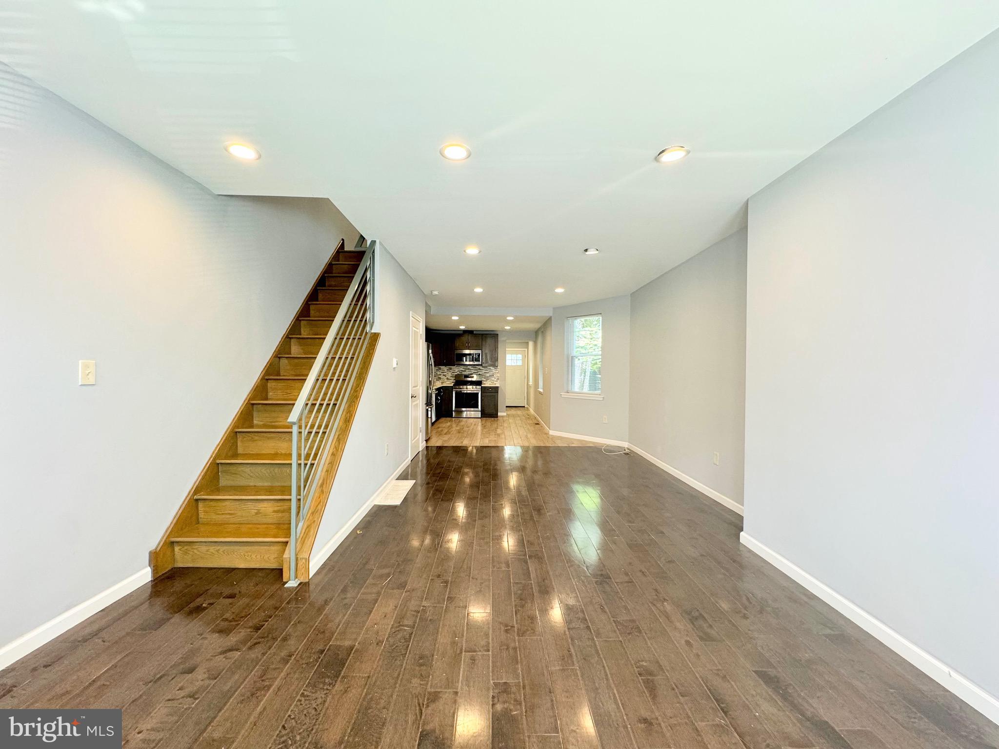 a view of entryway and hall with wooden floor