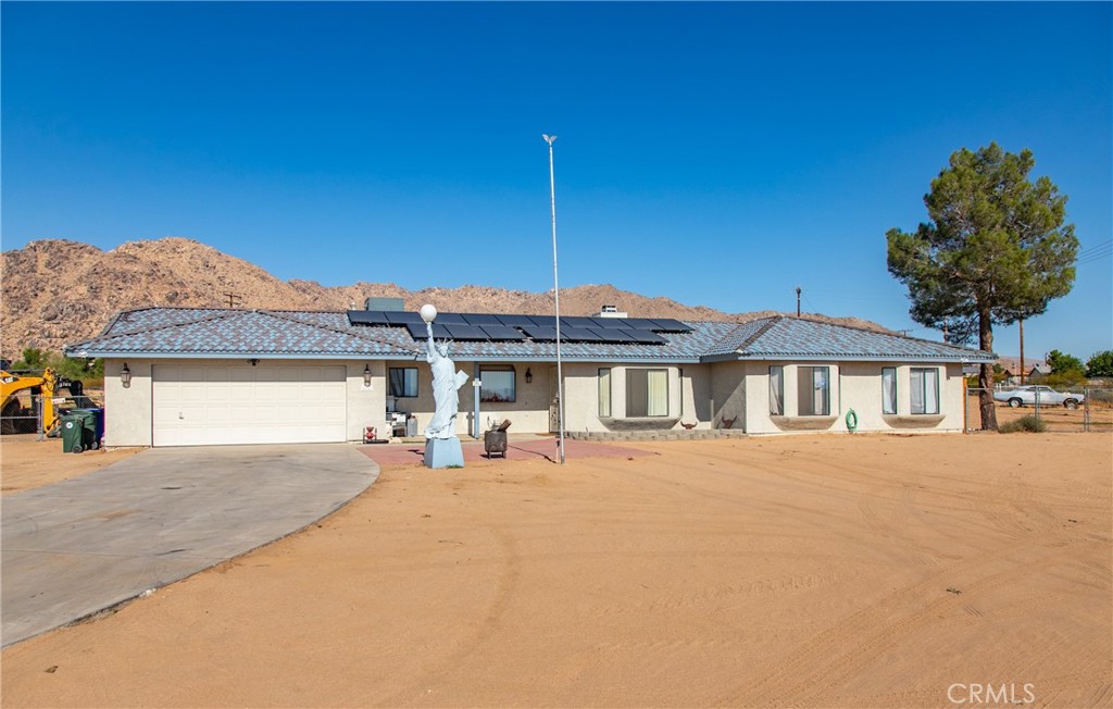 a view of a house with a yard and a garage