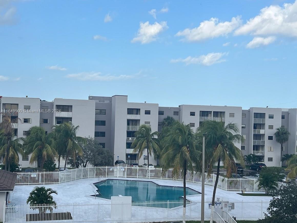 a view of building with yard and lake view