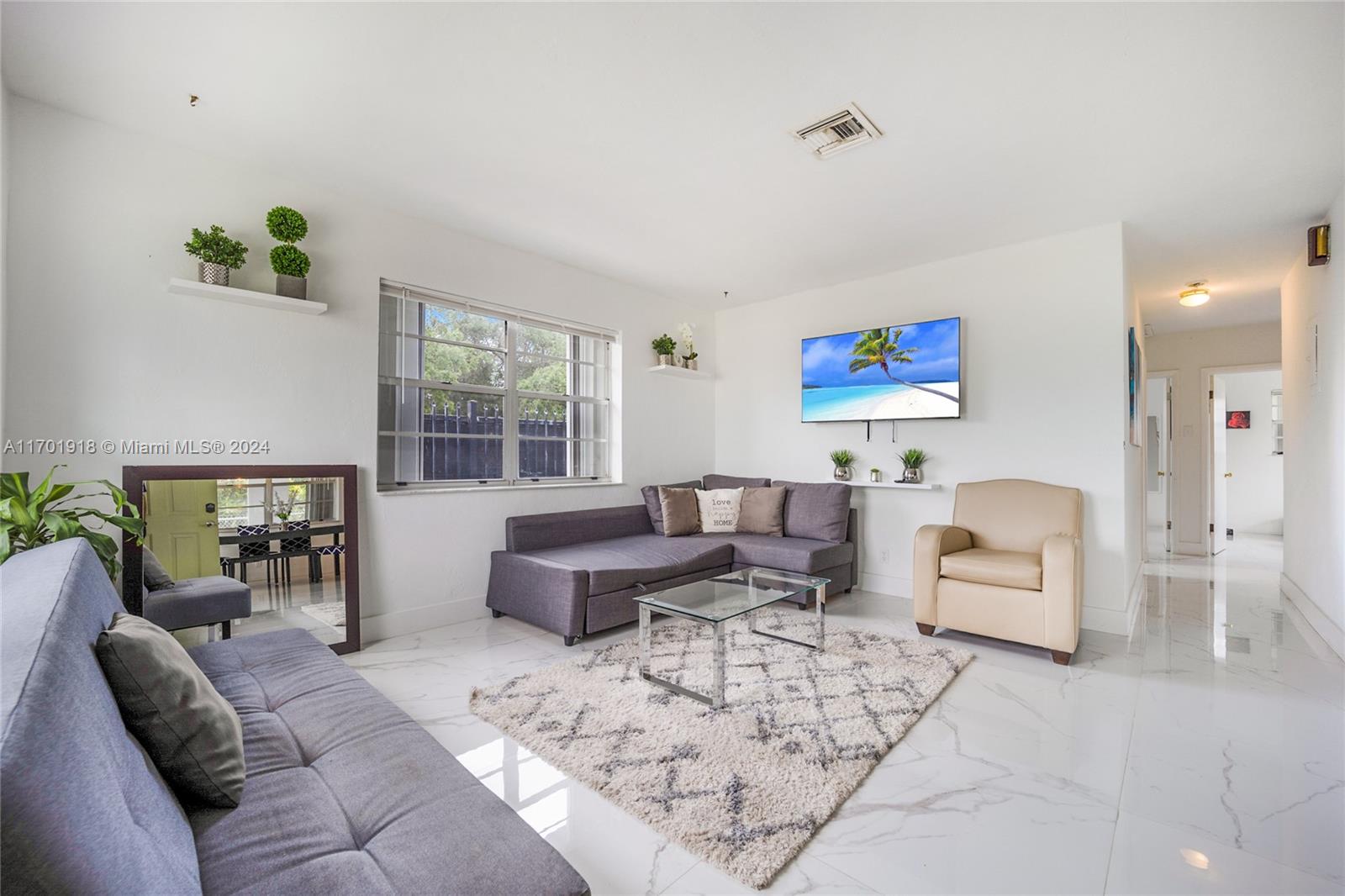 a living room with furniture rug and window