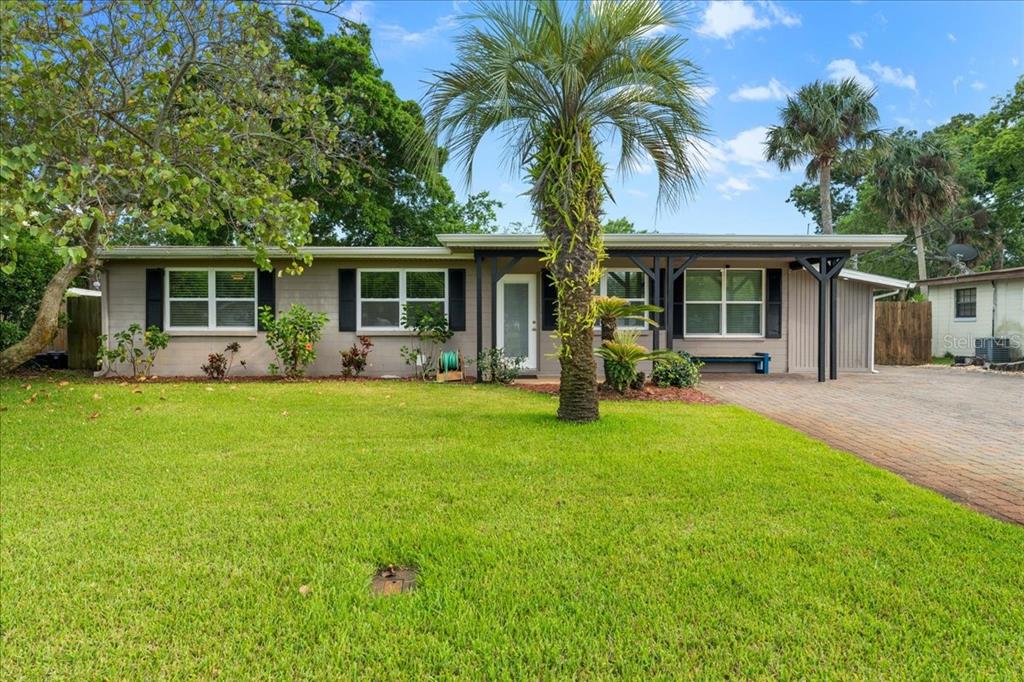 a front view of house with yard patio and green space