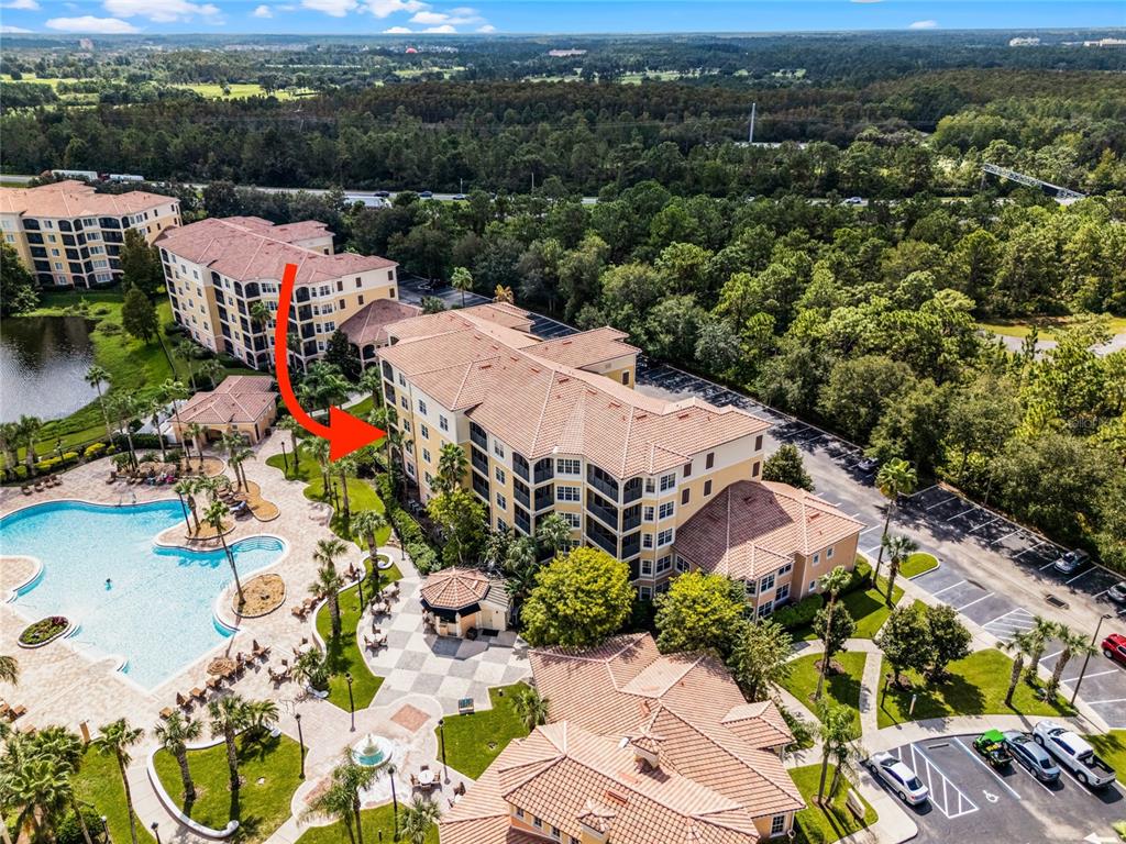 an aerial view of a houses with a swimming pool