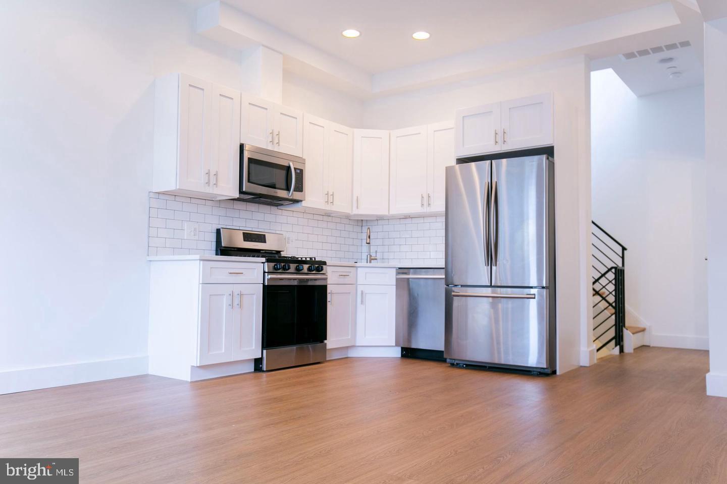 a kitchen with a refrigerator and a stove