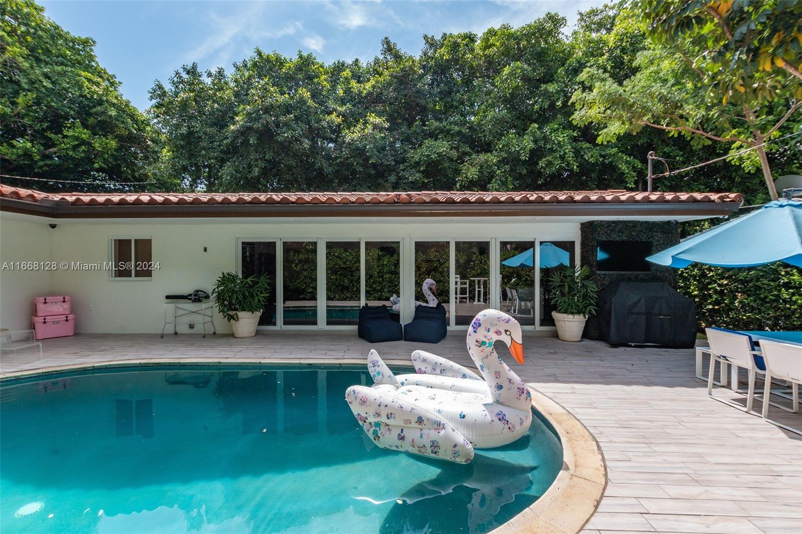 a front view of a house with patio furniture and garden