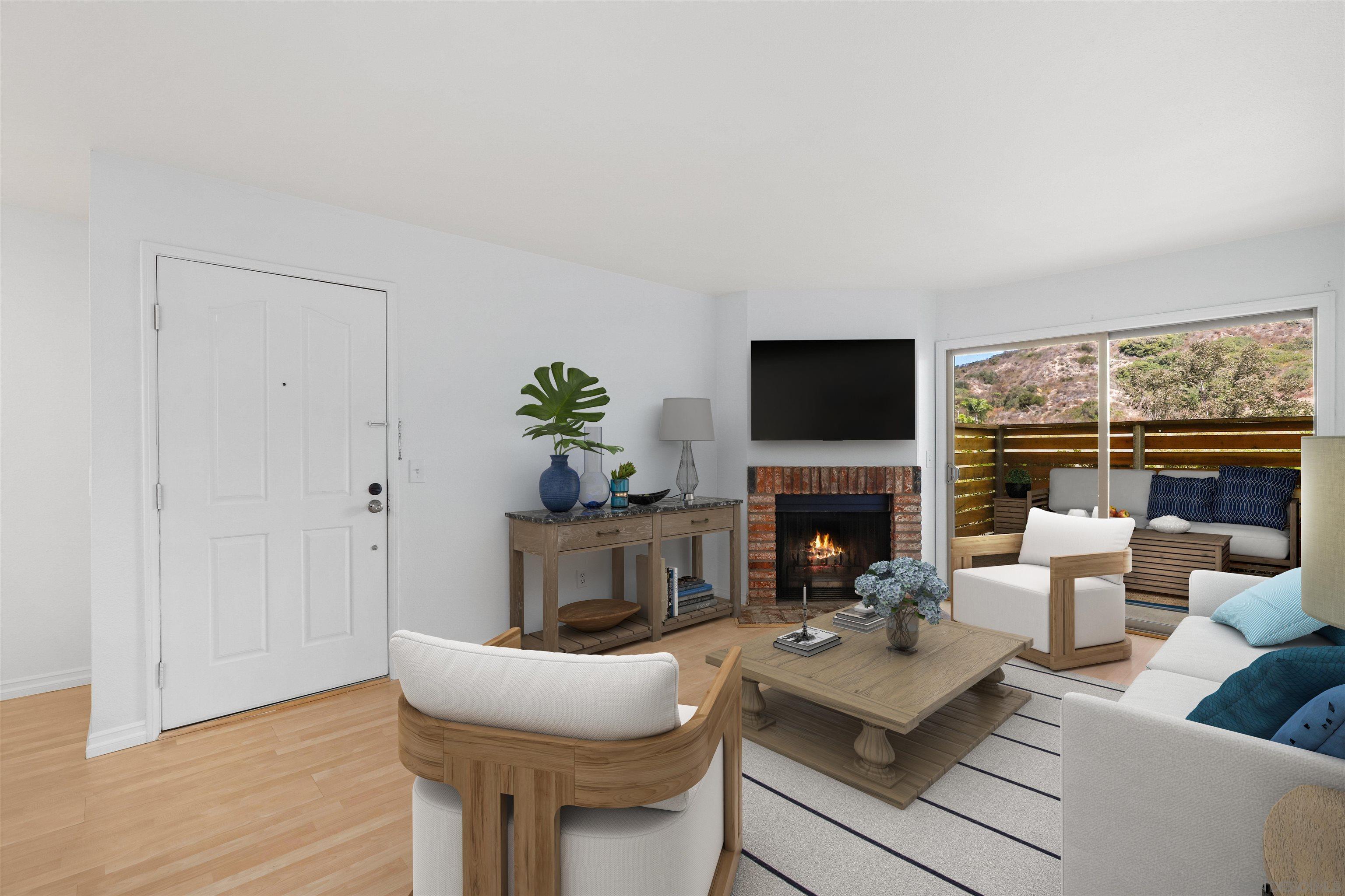 a living room with furniture a fireplace and a flat screen tv