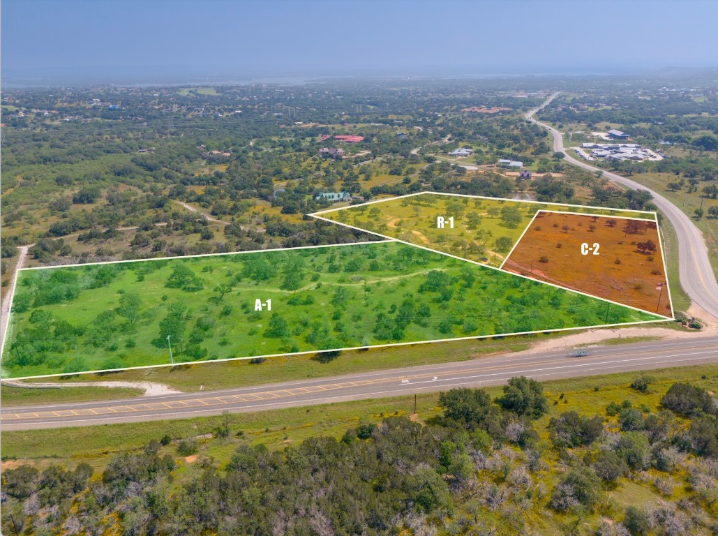 an aerial view of residential houses with outdoor space and city view