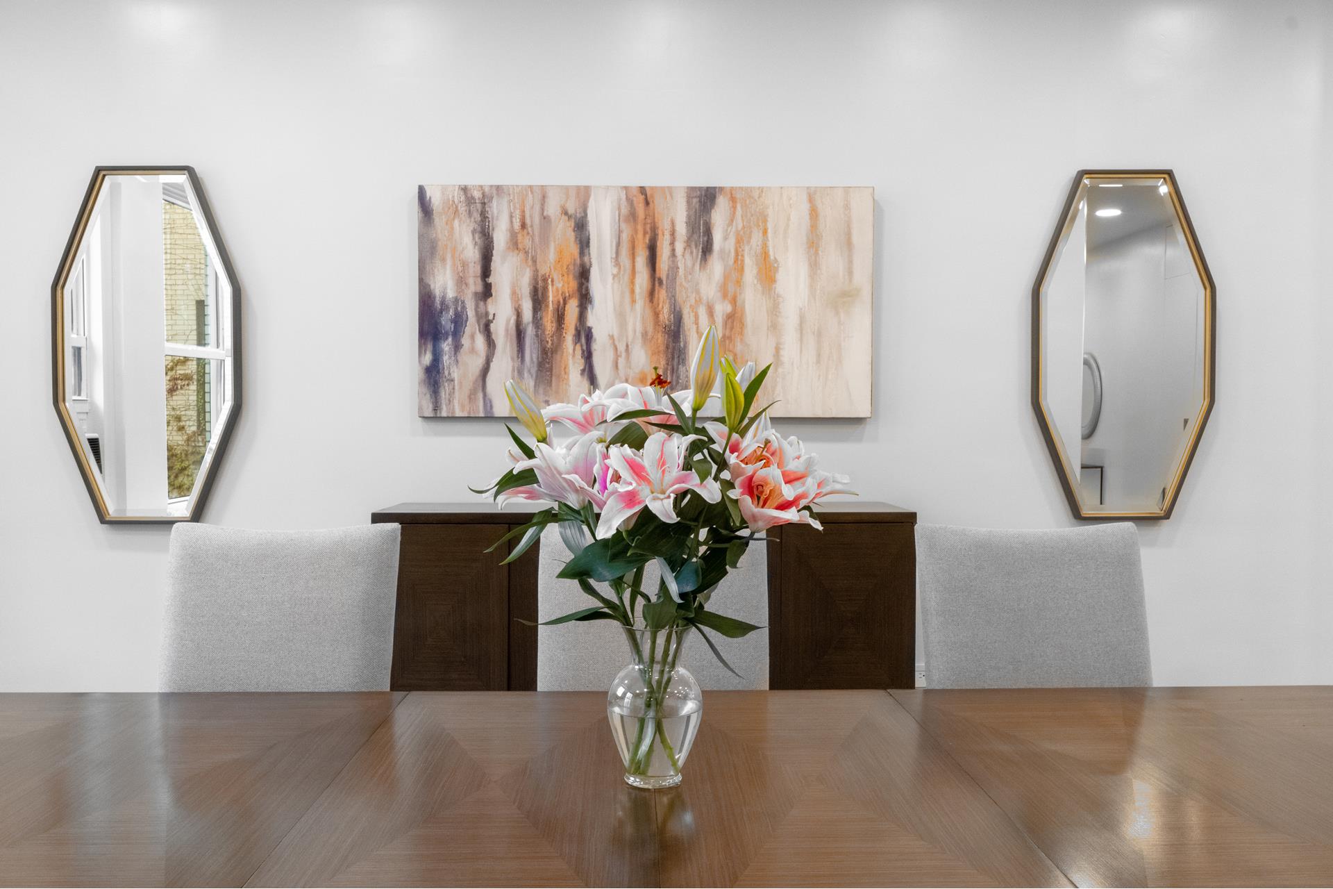 a view of a dining room with furniture and a mirror