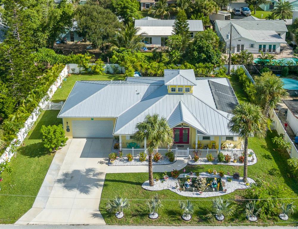 a aerial view of a house with swimming pool patio and outdoor seating