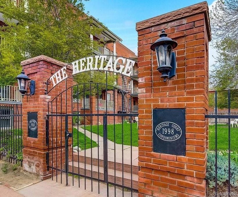 a view of a brick wall with a small yard