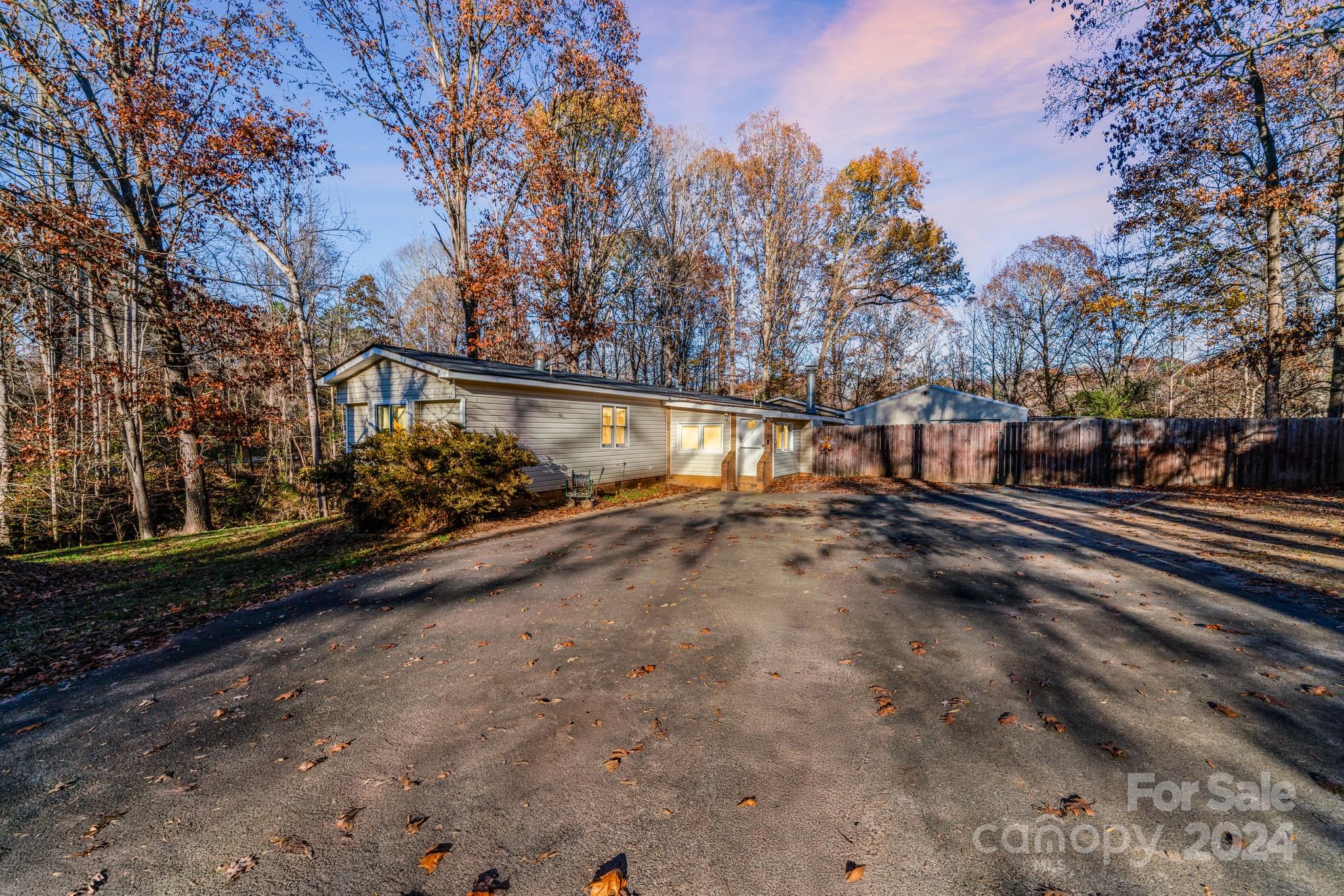 a view of a road with wooden fence