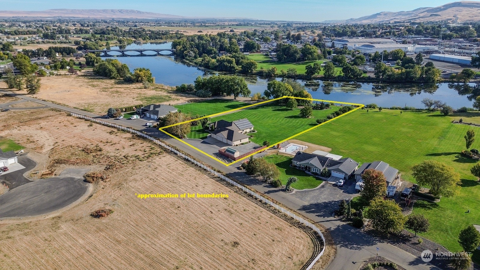 an aerial view of a house with a swimming pool yard and outdoor seating