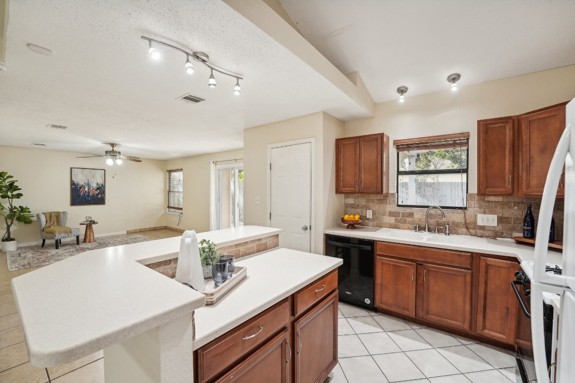 a kitchen with a sink stove and cabinets