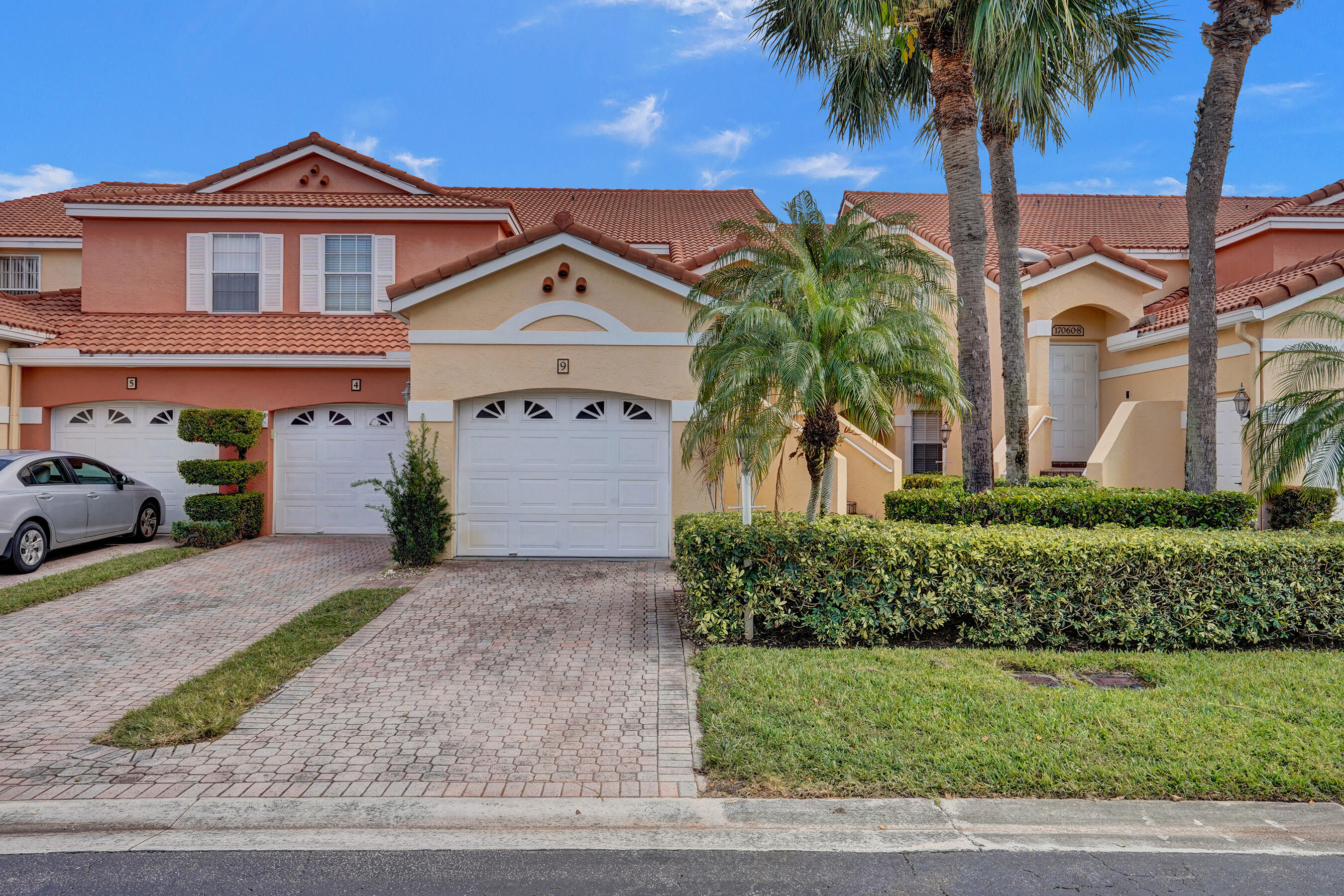 a front view of a house with a yard and garage