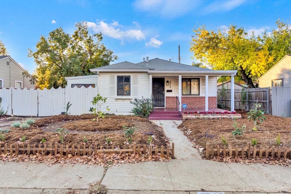 a front view of a house with a garden