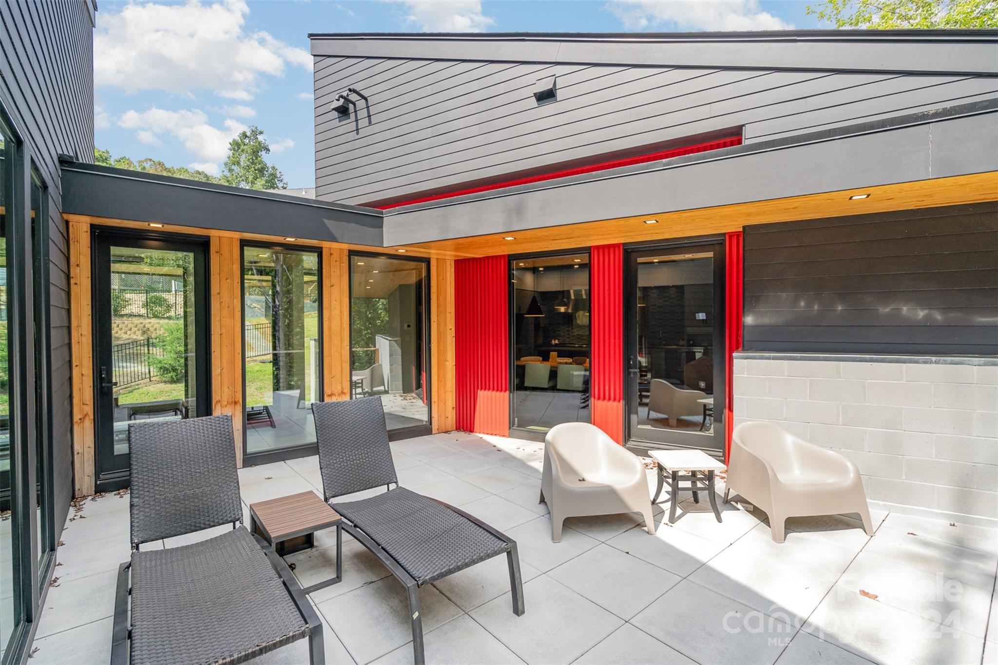 a view of a patio with a dining table and chairs