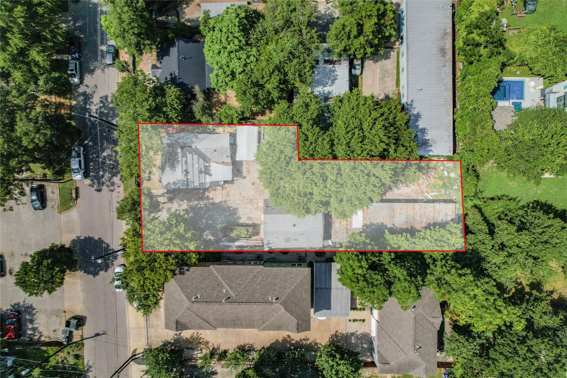 an aerial view of a house with a yard and large tree