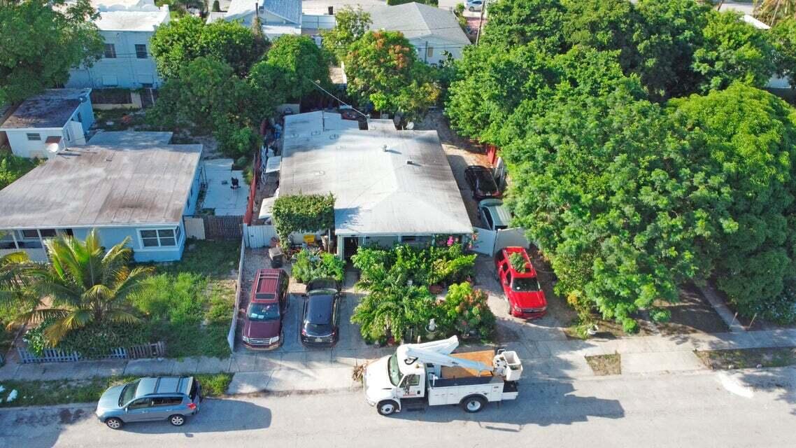 an aerial view of a house with yard and garage