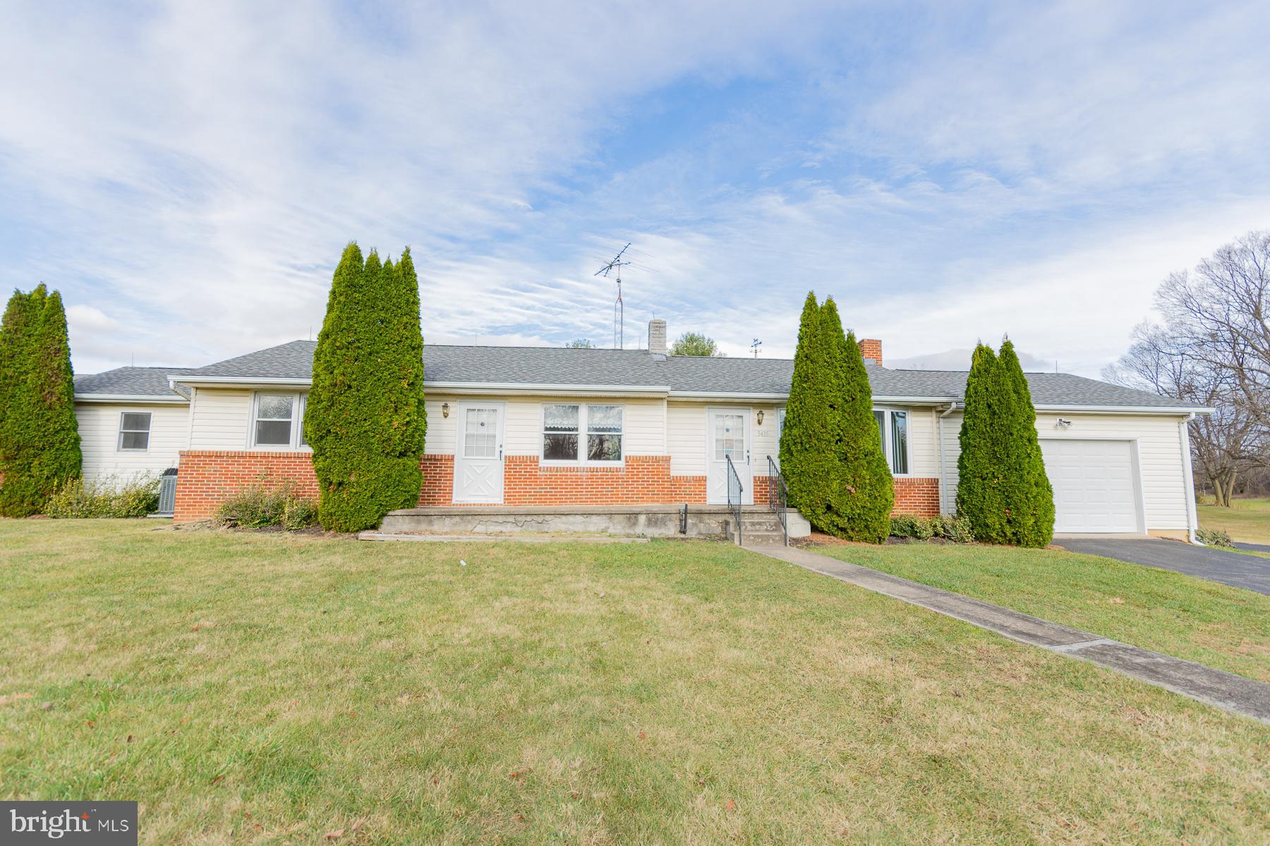 a view of a house with a yard and garage