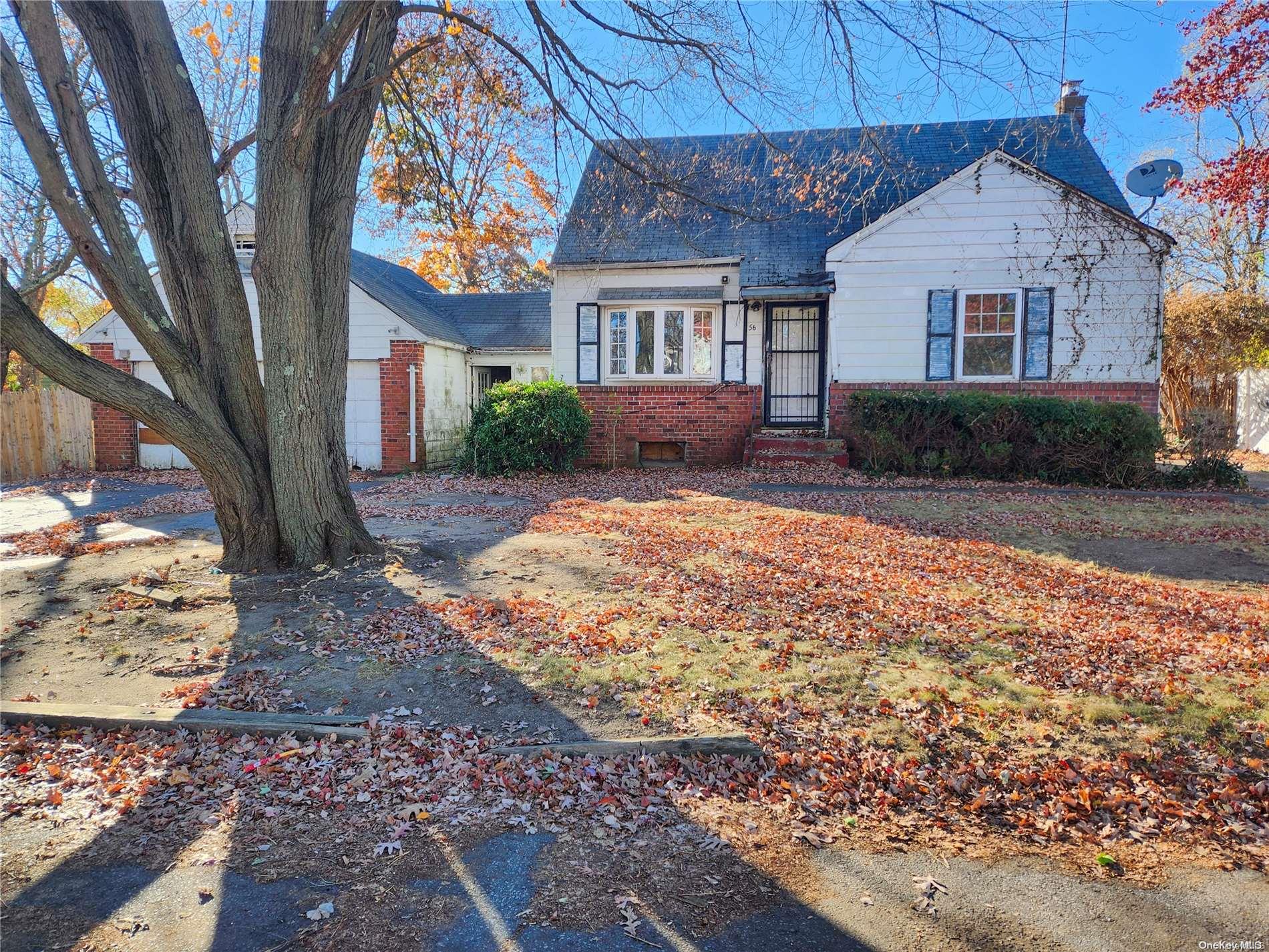 a view of a house with a tree in front of it