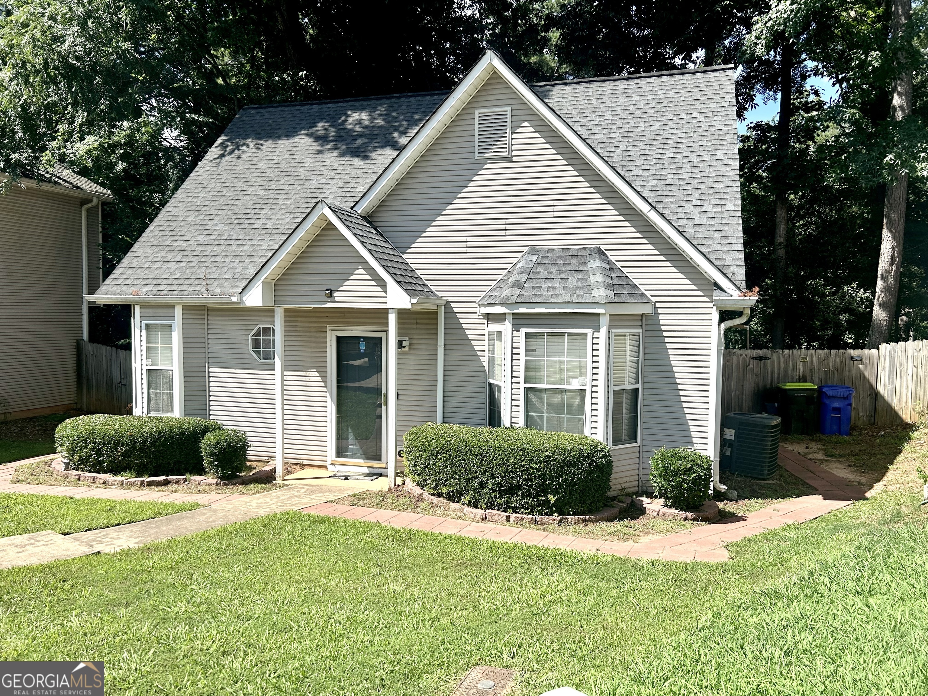 a view of a house with a yard and plants