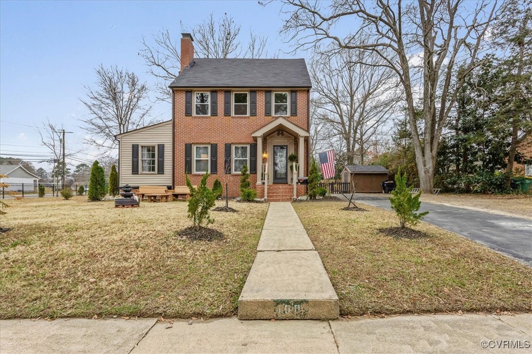 View of front of home featuring an outbuilding and