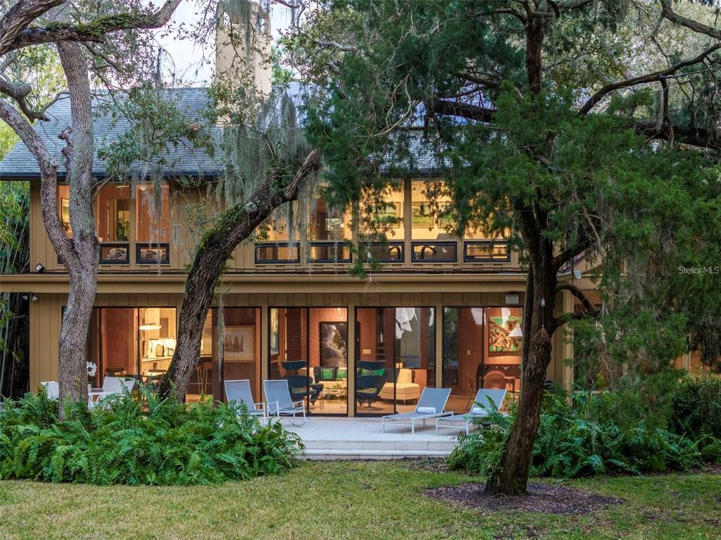 front view of house with a garden and trees