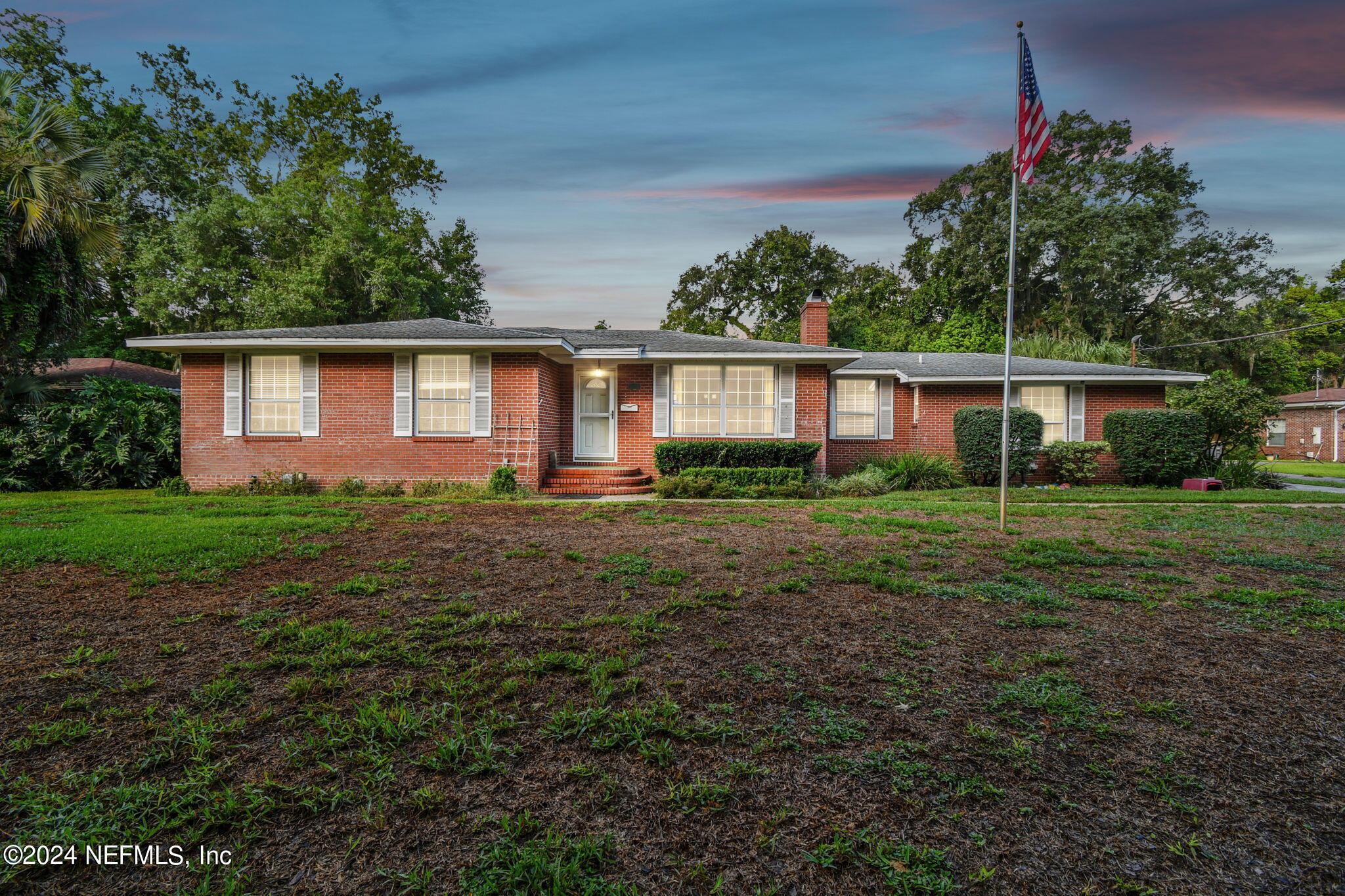 a front view of house with yard and green space