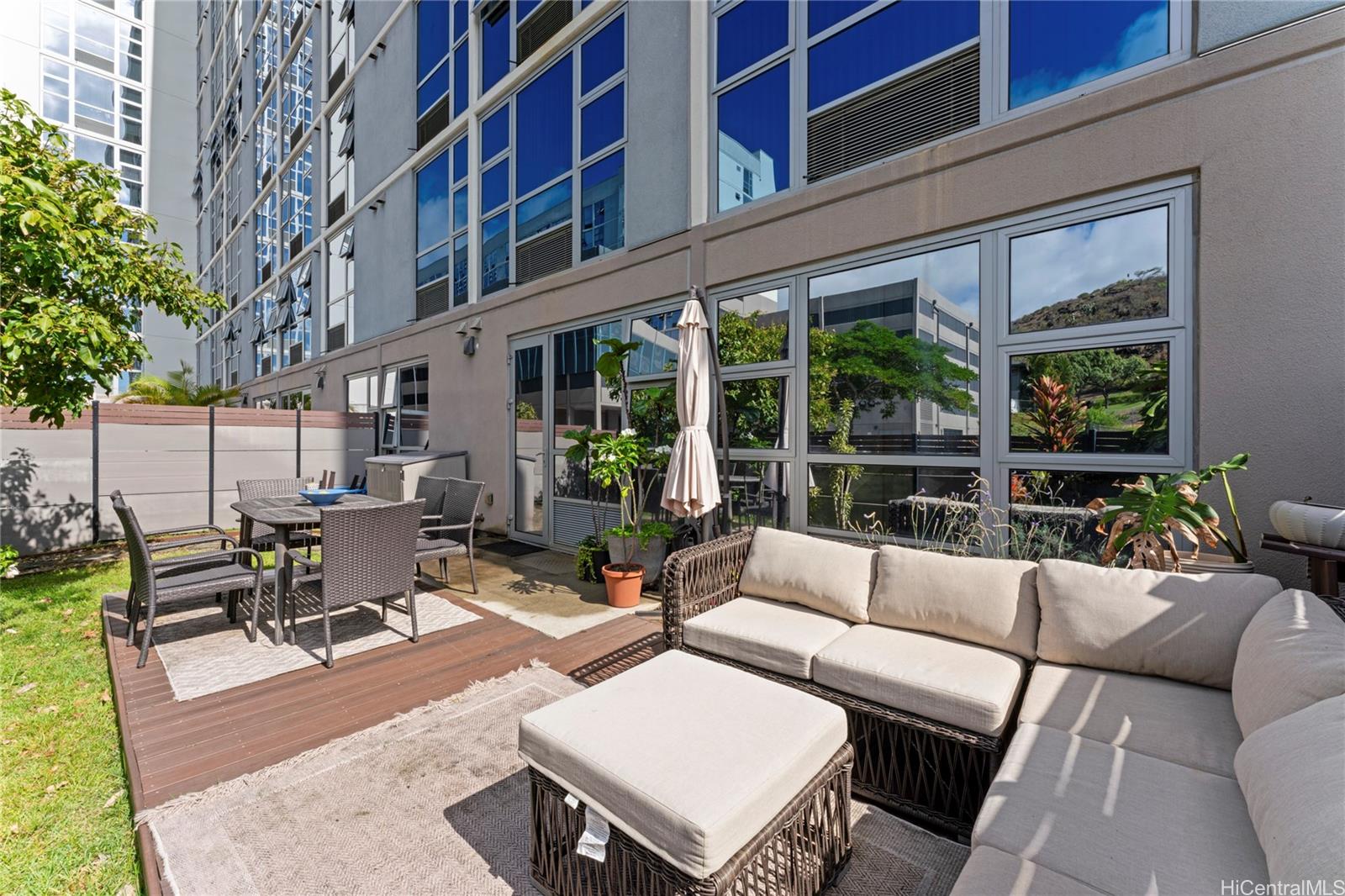 a view of a patio with couches and a table and chairs with garden view