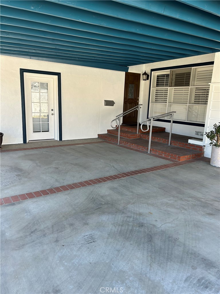 a view of a room with wooden floor and windows