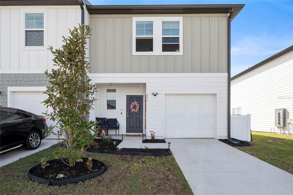 a view of a house with a yard and garage