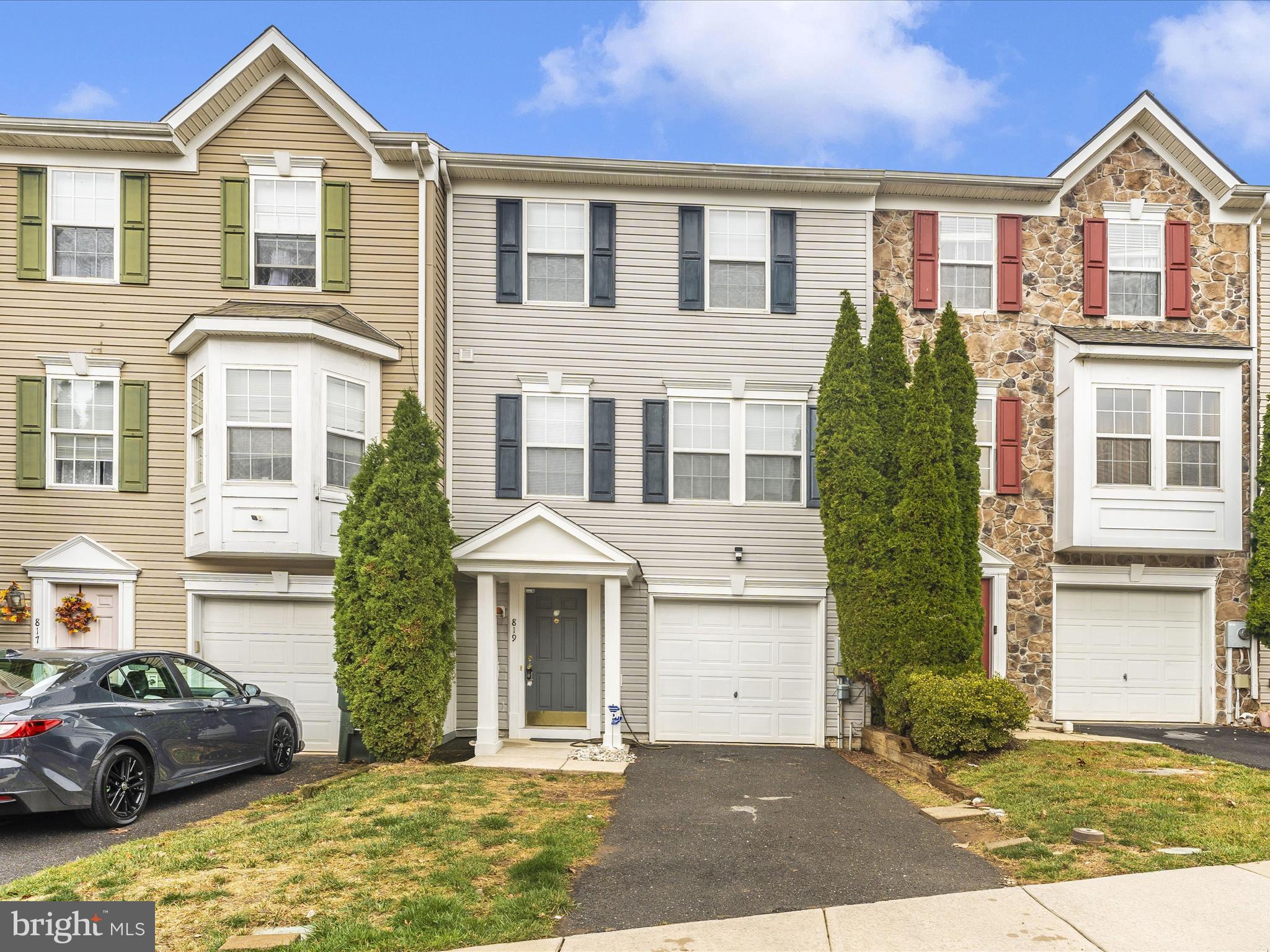 a front view of a residential houses with yard