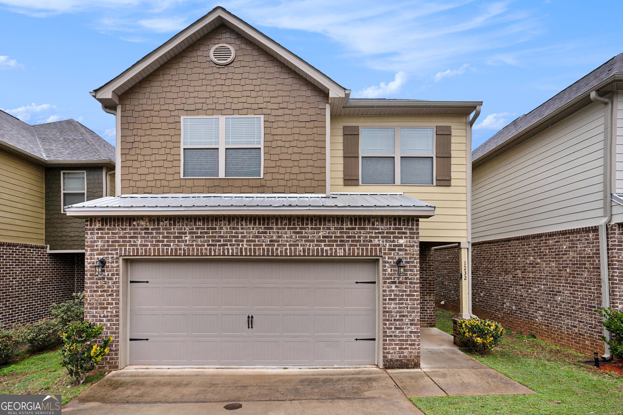 a front view of a house with garage