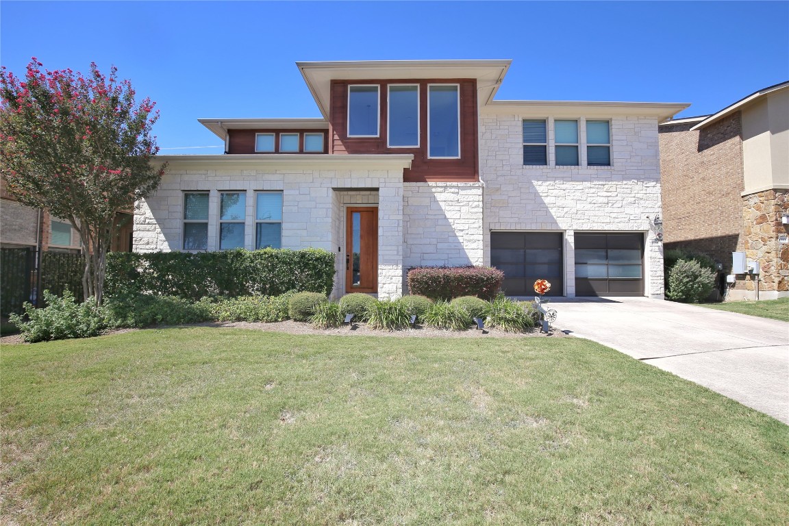 a front view of a house with a yard and garage