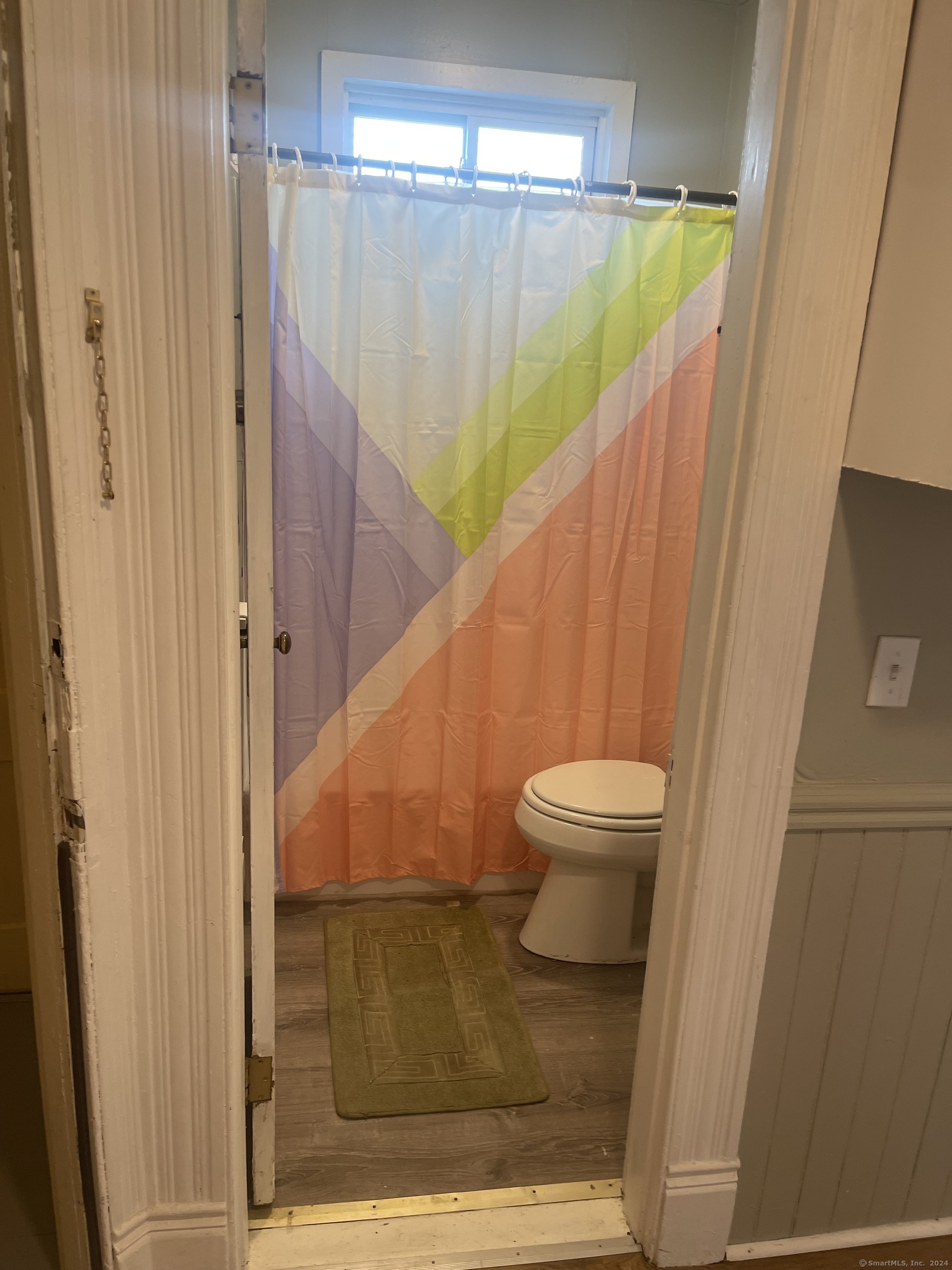 a bathroom with a toilet and a shower