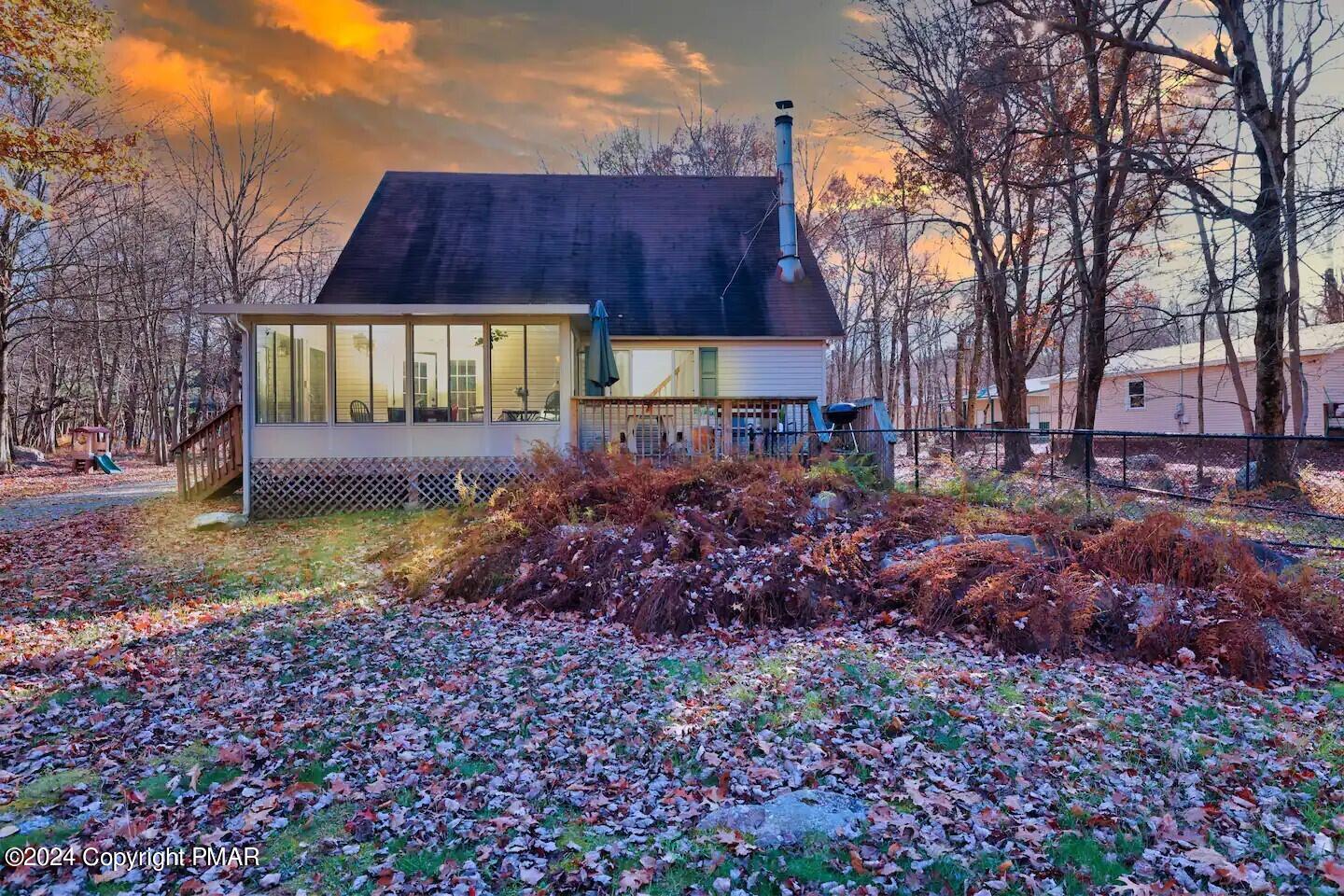 a view of a house with a yard and sitting area