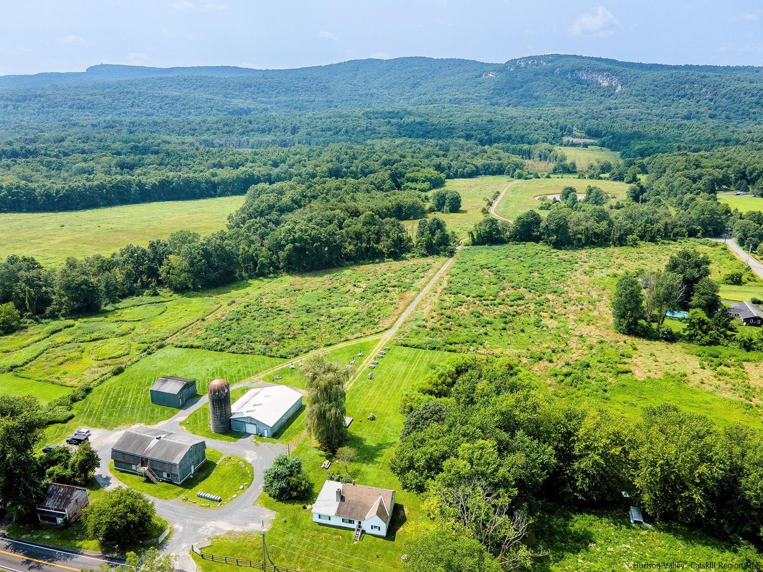 an aerial view of a house with yard