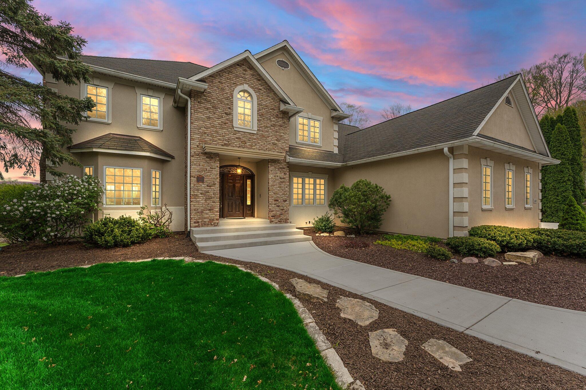 a front view of a house with a yard and garage