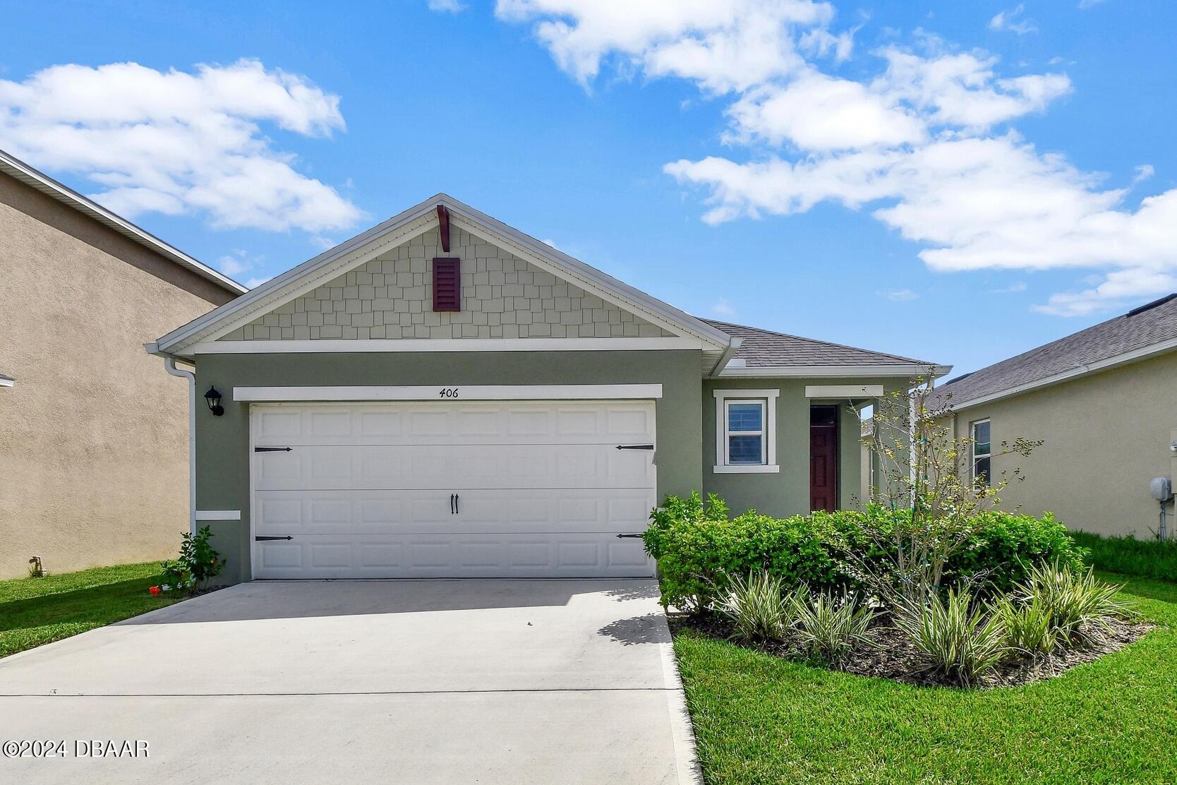 a front view of a house with garage