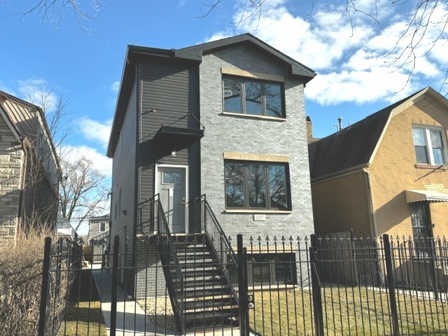 a front view of a house with glass windows