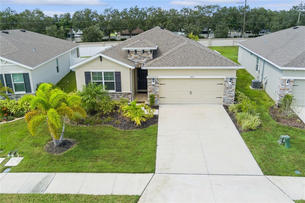 a aerial view of residential houses with yard and green space