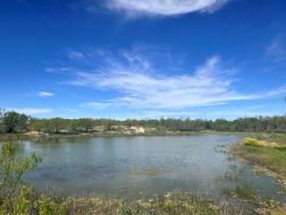 a view of a lake with houses in the back