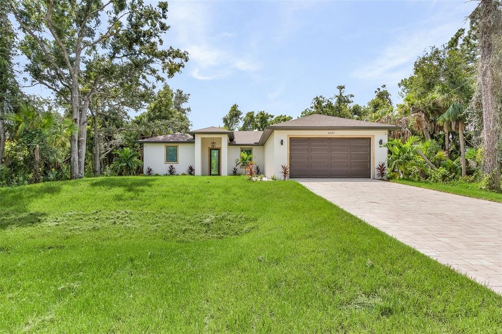 a front view of house with yard and green space