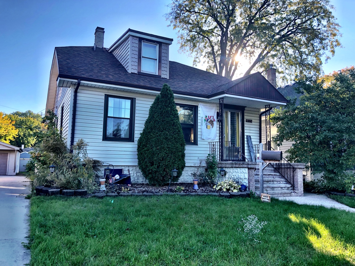 a front view of a house with a garden and plants