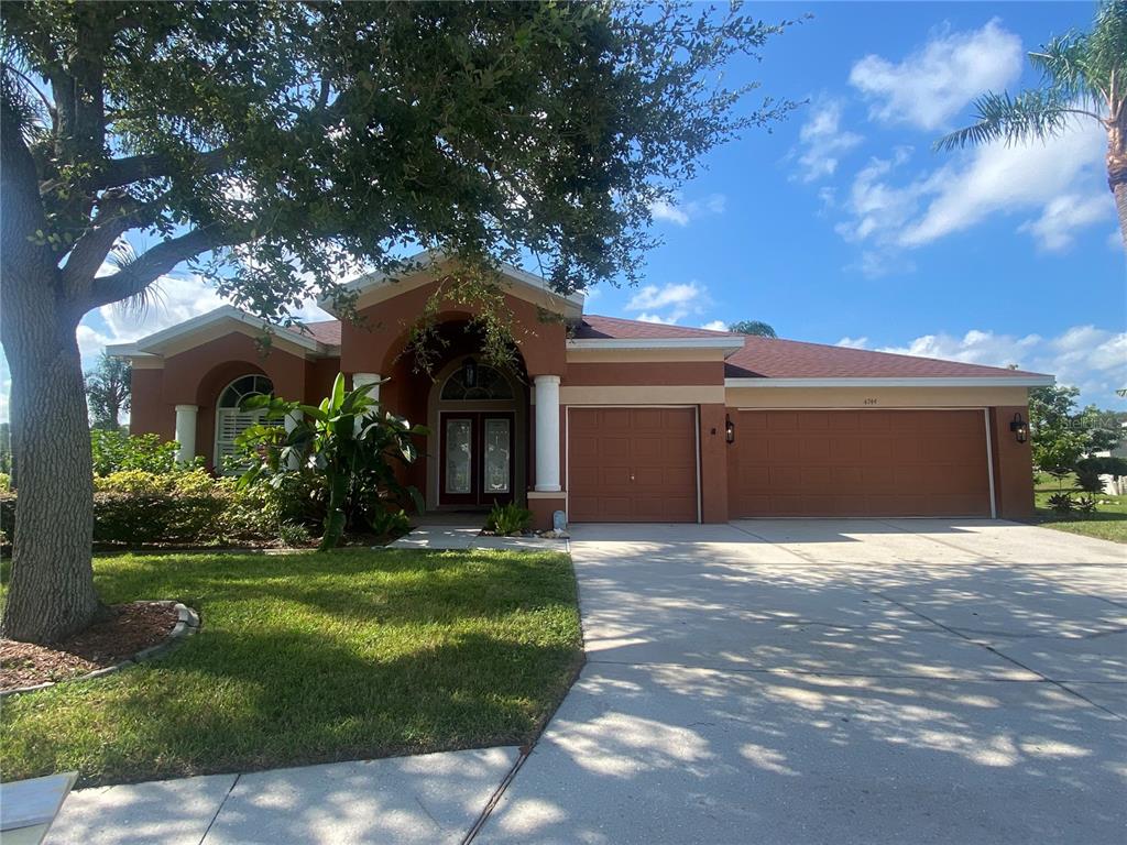 a front view of a house with a yard and garage