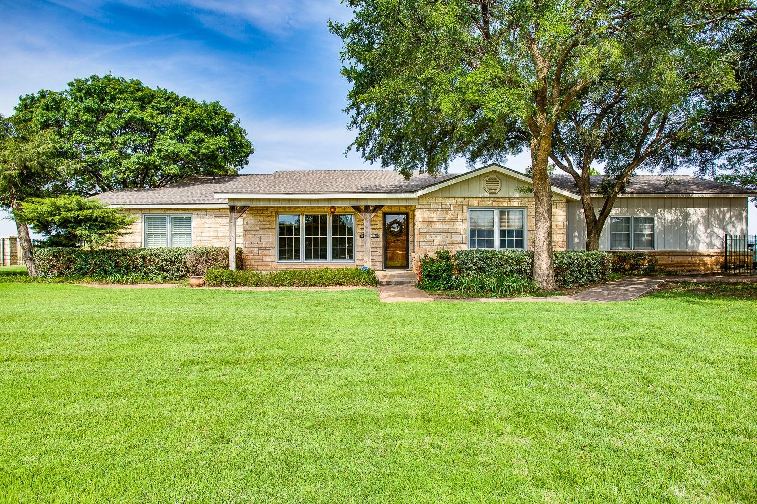 a front view of house with yard and green space